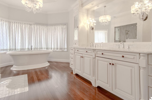 bathroom with vanity, hardwood / wood-style flooring, separate shower and tub, ornamental molding, and a notable chandelier