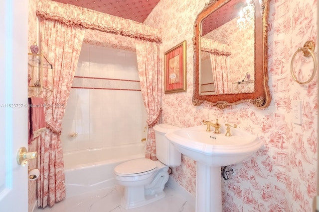 bathroom featuring tiled shower / bath combo and toilet