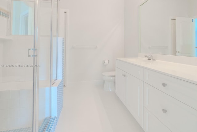 bathroom with vanity, toilet, and walk in shower