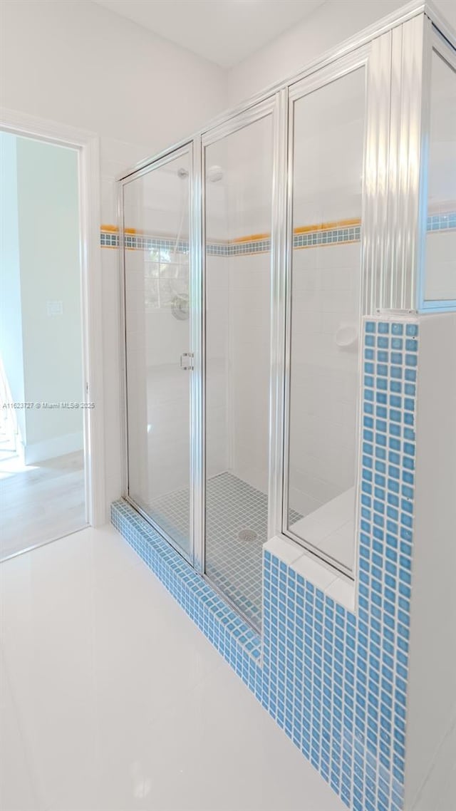 bathroom featuring tile patterned floors and an enclosed shower