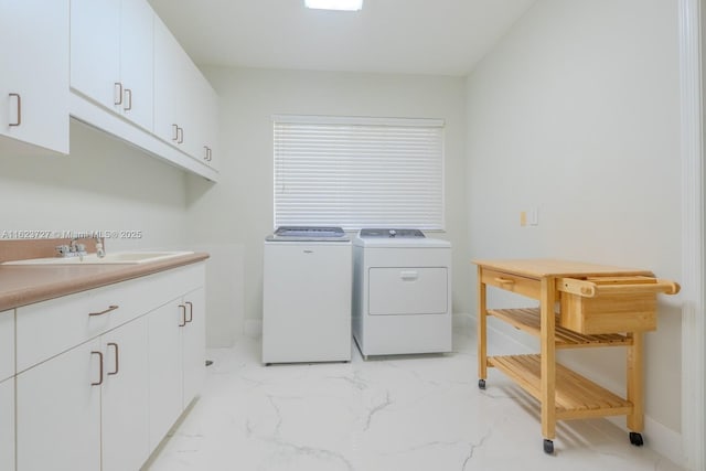 laundry area with washer and dryer, cabinets, and sink