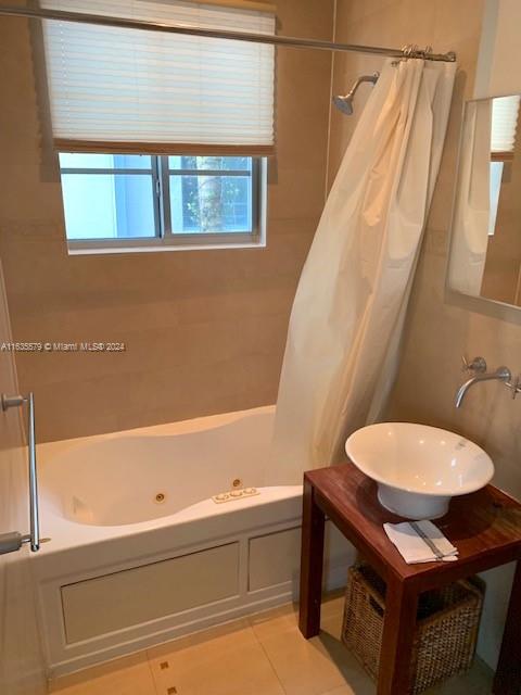 bathroom featuring sink, shower / tub combo, and tile patterned floors