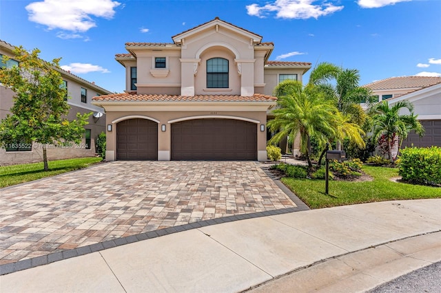 mediterranean / spanish-style house with a garage