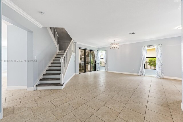 unfurnished living room featuring a chandelier, light tile patterned floors, and crown molding