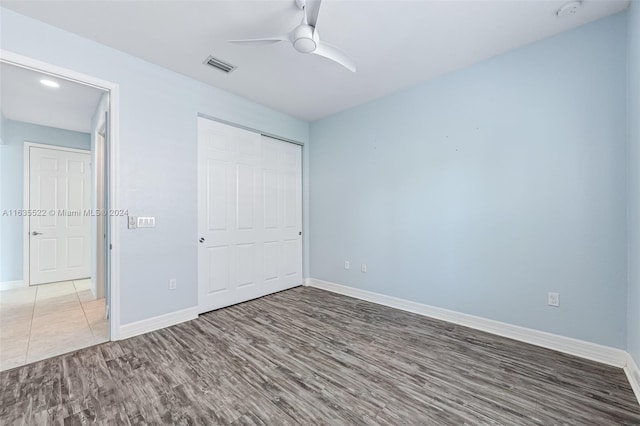 unfurnished bedroom featuring a closet, ceiling fan, and hardwood / wood-style floors