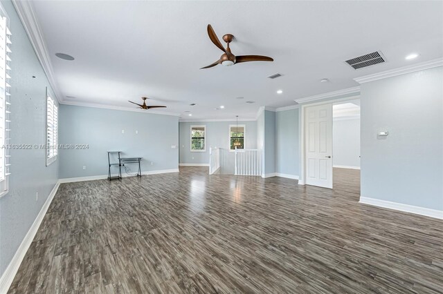 unfurnished living room featuring dark wood-type flooring, ceiling fan, and ornamental molding