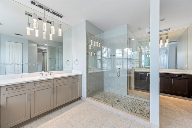 bathroom with dual vanity, tile patterned flooring, and an enclosed shower