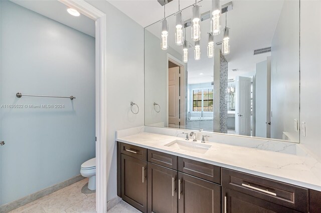 bathroom with tile patterned flooring, toilet, and vanity