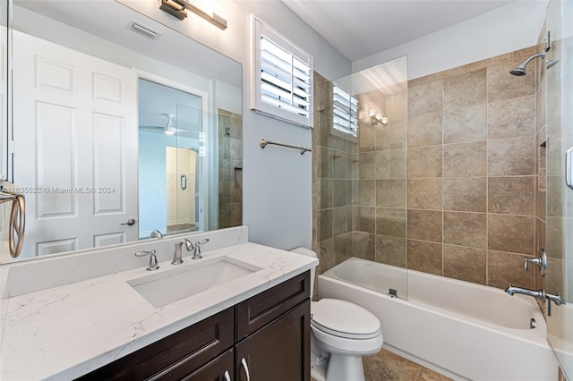 full bathroom with tile patterned flooring, toilet, vanity, and tiled shower / bath