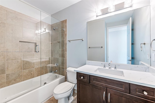 full bathroom featuring tile patterned floors, vanity, combined bath / shower with glass door, and toilet