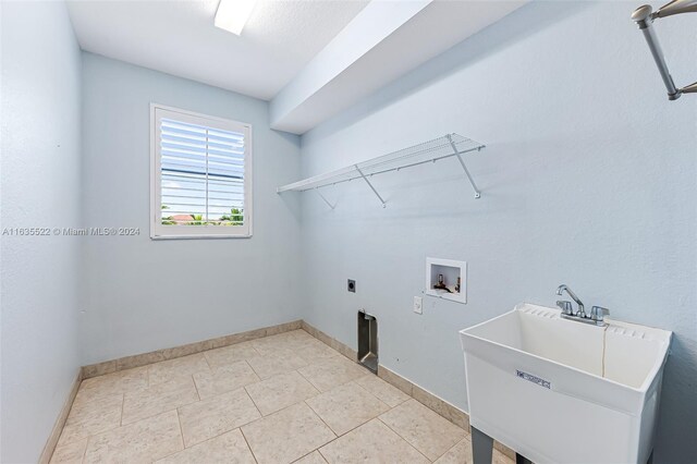 washroom with tile patterned flooring, hookup for a washing machine, hookup for an electric dryer, and sink