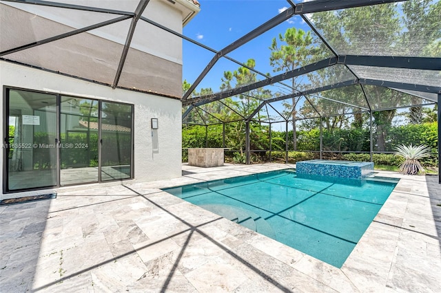 view of swimming pool featuring an in ground hot tub, a patio area, and a lanai