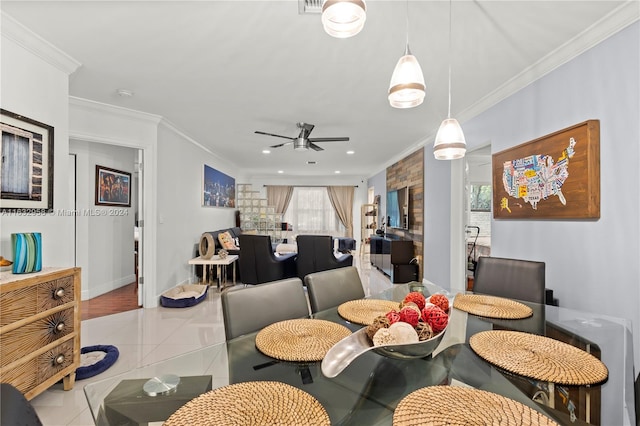 dining room featuring tile patterned floors, ceiling fan, and ornamental molding