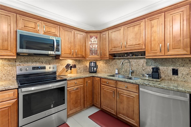 kitchen featuring light tile patterned flooring, stainless steel appliances, sink, light stone countertops, and backsplash