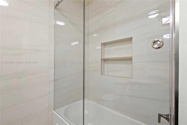 bathroom featuring toilet and enclosed tub / shower combo