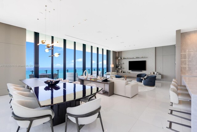 dining space featuring floor to ceiling windows, light tile patterned floors, and a water view