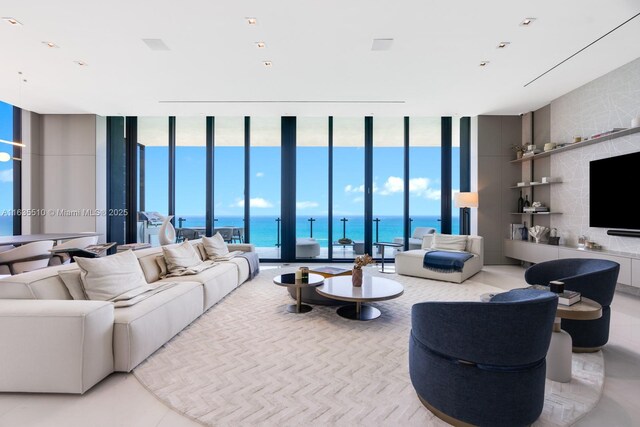 tiled living room featuring floor to ceiling windows and a wealth of natural light