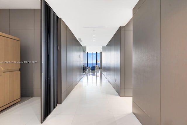 17141 Collins Ave Unit 2501, Sunny Isles Beach, FL 33160 - hallway with light tile patterned floors and a wall of windows