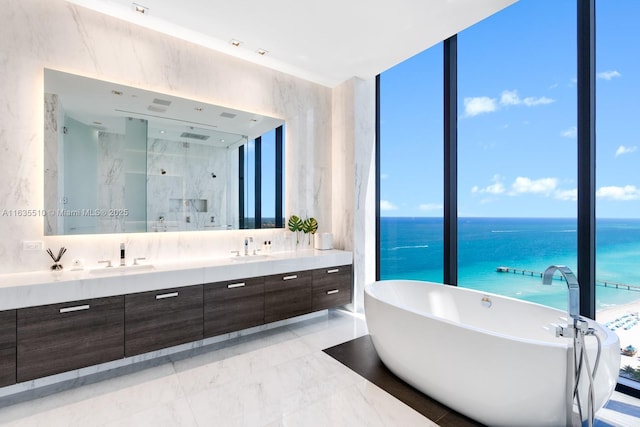 17141 Collins Ave Unit 2501, Sunny Isles Beach, FL 33160 - bathroom featuring a water view, expansive windows, vanity, and plus walk in shower