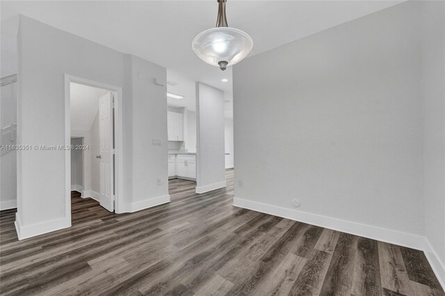 unfurnished dining area featuring dark hardwood / wood-style floors