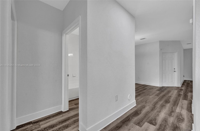 corridor with hardwood / wood-style floors