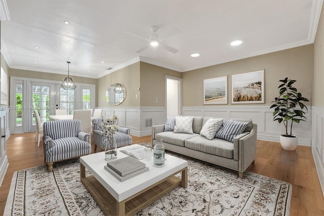 living room with french doors, light hardwood / wood-style flooring, and ornamental molding