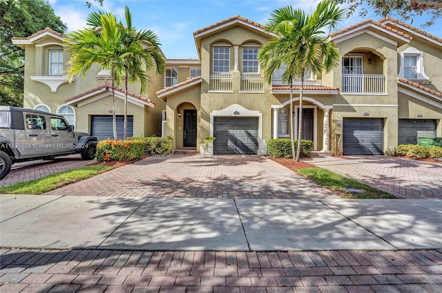 view of front of property with a garage and a balcony