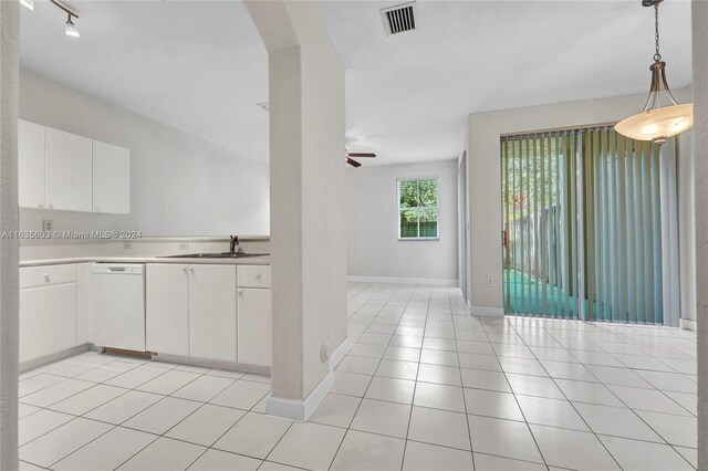 kitchen featuring white cabinets, track lighting, white dishwasher, light tile patterned floors, and ceiling fan