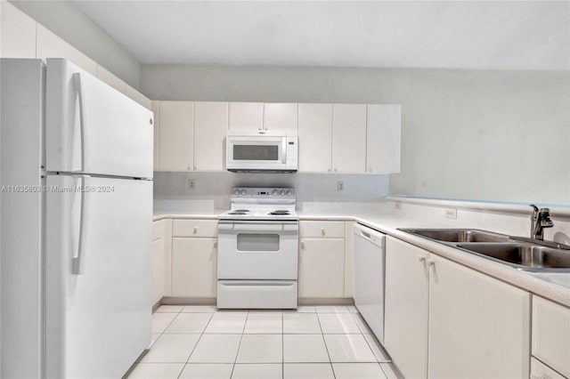 kitchen featuring white cabinetry, sink, white appliances, and light tile patterned floors