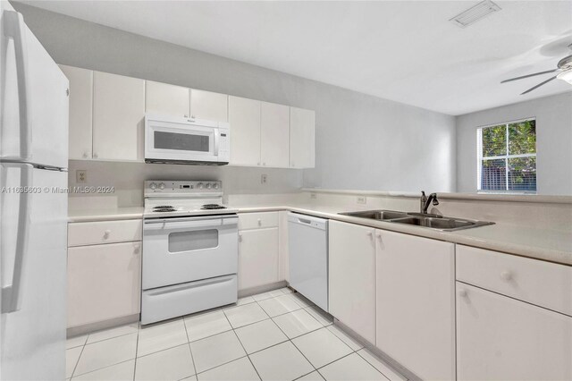 kitchen with white appliances, white cabinets, sink, light tile patterned flooring, and ceiling fan