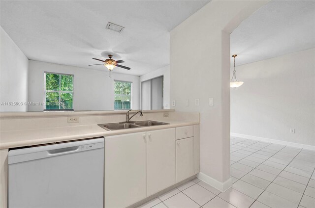 kitchen with light tile patterned floors, dishwasher, ceiling fan, decorative light fixtures, and sink