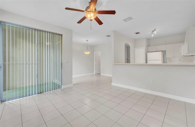 spare room featuring light tile patterned flooring and ceiling fan