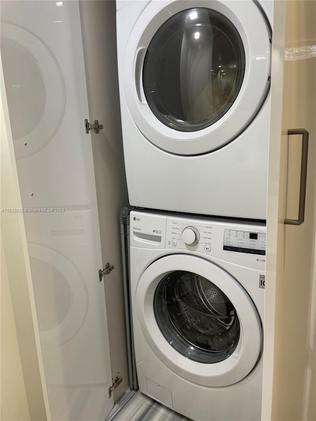 laundry area featuring stacked washer / drying machine