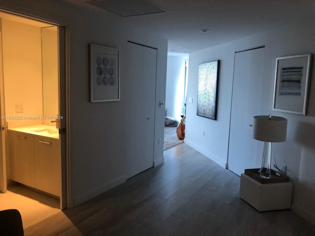 hallway featuring hardwood / wood-style flooring and sink