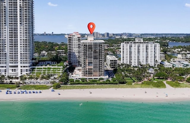 birds eye view of property featuring a view of the beach and a water view