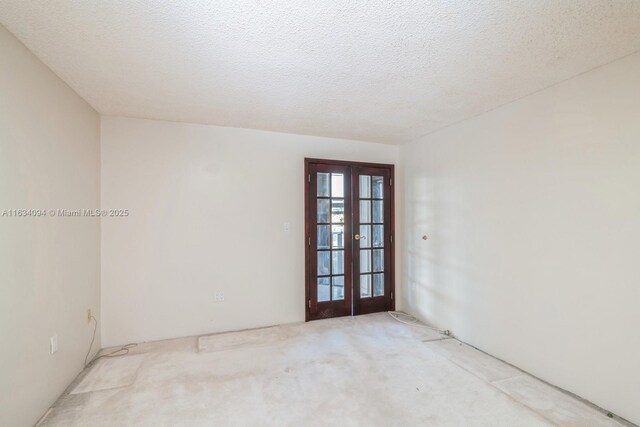 bathroom featuring vanity, a shower with shower door, and a textured ceiling