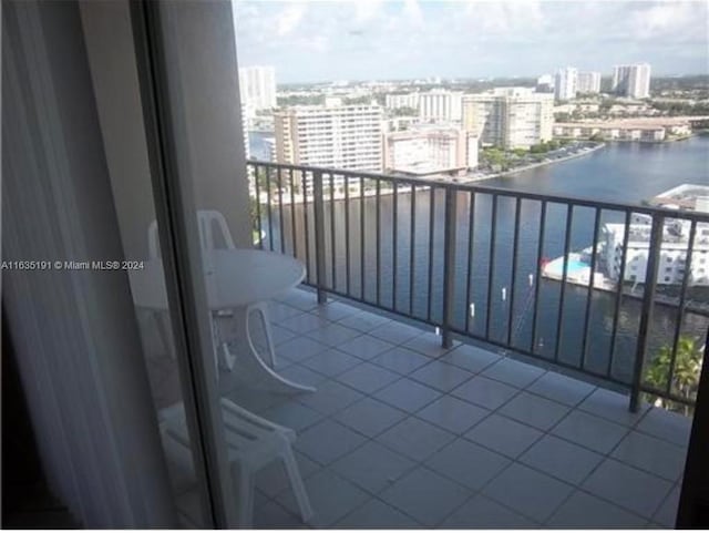 balcony featuring a city view and a water view