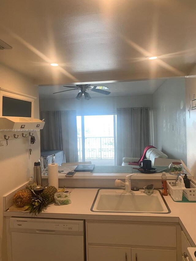 kitchen with ceiling fan, sink, white dishwasher, and white cabinets