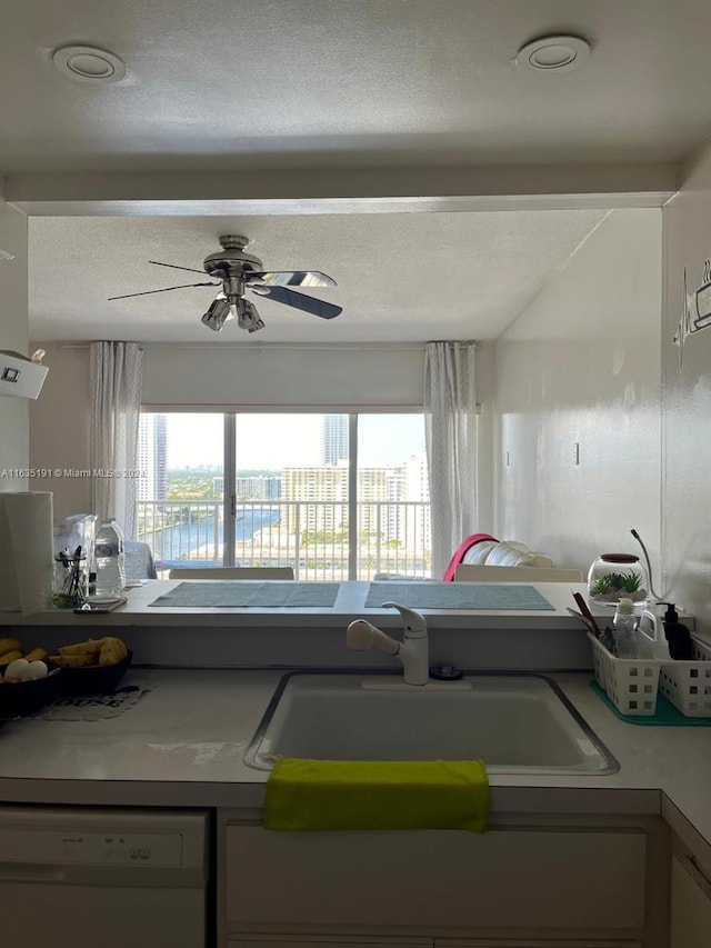 kitchen with sink, a textured ceiling, dishwasher, and ceiling fan