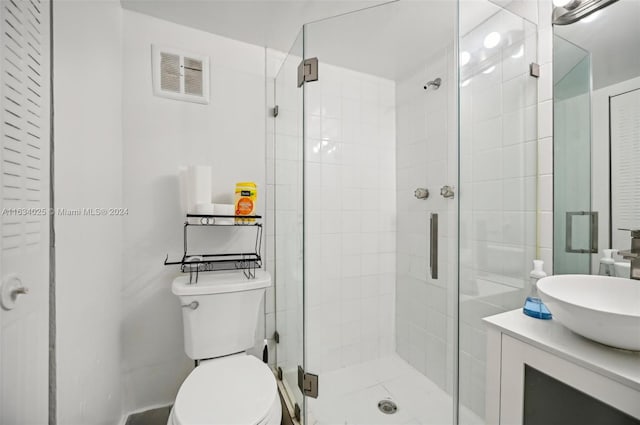 bathroom with vanity, toilet, and an enclosed shower