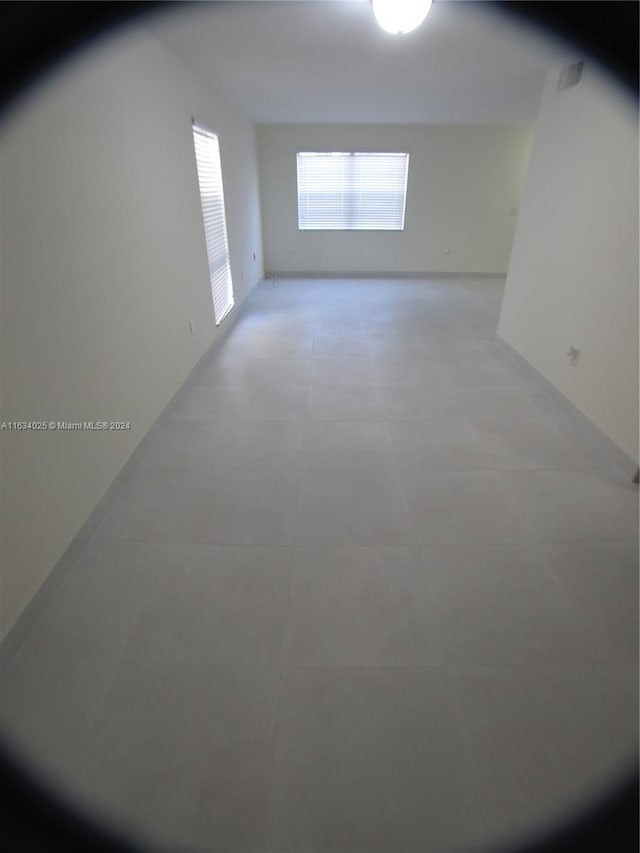 additional living space featuring light tile patterned flooring