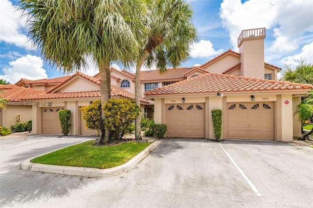 mediterranean / spanish home with a garage