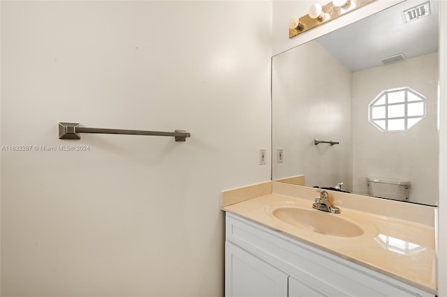 bathroom with toilet and vanity