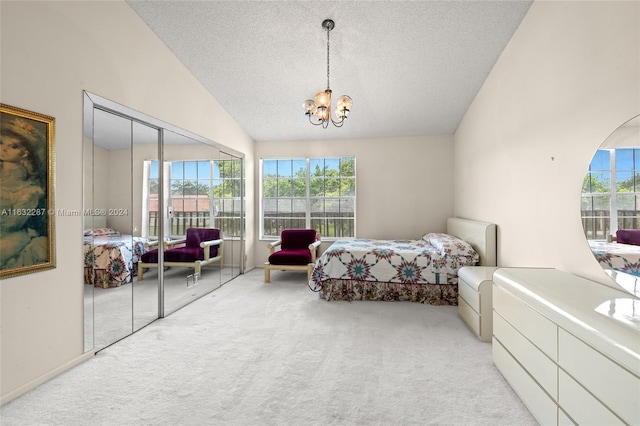 carpeted bedroom with high vaulted ceiling, a textured ceiling, a closet, and a notable chandelier