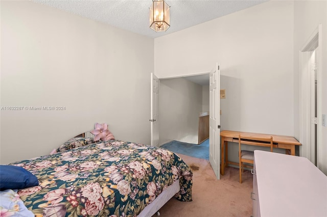 bedroom with light carpet and a textured ceiling