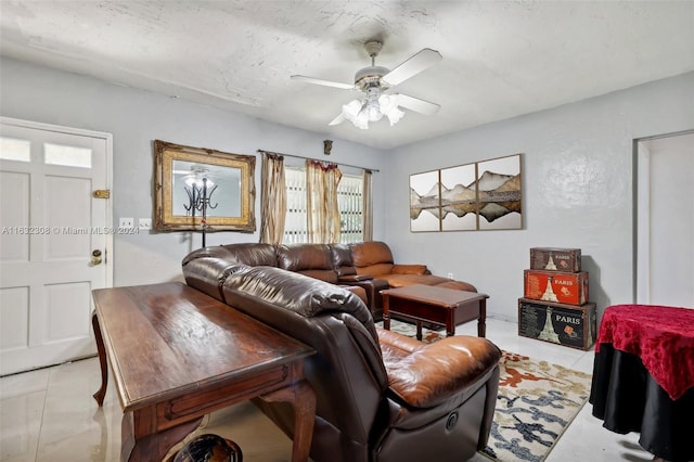 tiled living room featuring a textured ceiling and ceiling fan