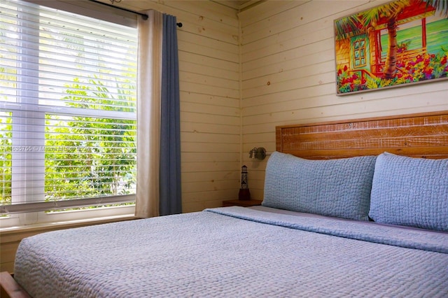 unfurnished bedroom featuring tile patterned flooring and wood walls