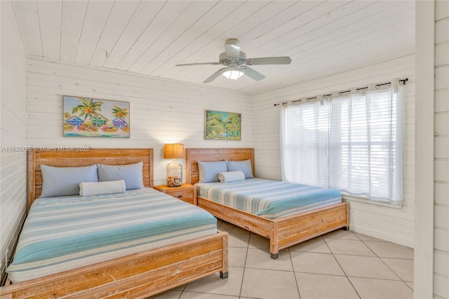 bedroom with light tile patterned floors, wood ceiling, and a ceiling fan