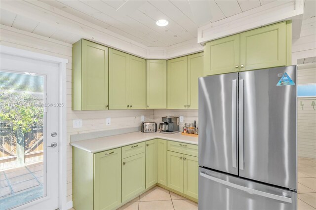 clothes washing area featuring washer and dryer, plenty of natural light, wooden walls, and cabinets