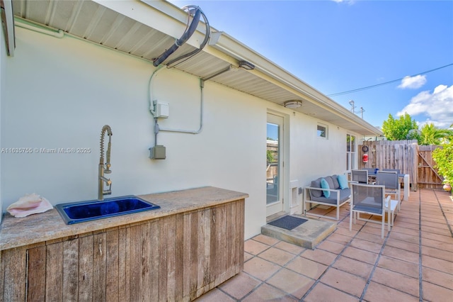 view of patio / terrace with fence and a sink